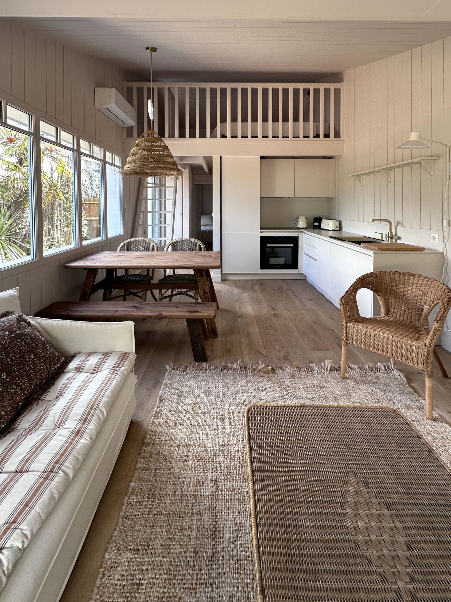 Vista completa della maison a Cap Ferret con cucina Zecchinon, soppalco e zona pranzo, progetto su misura di Quartier Cuisine