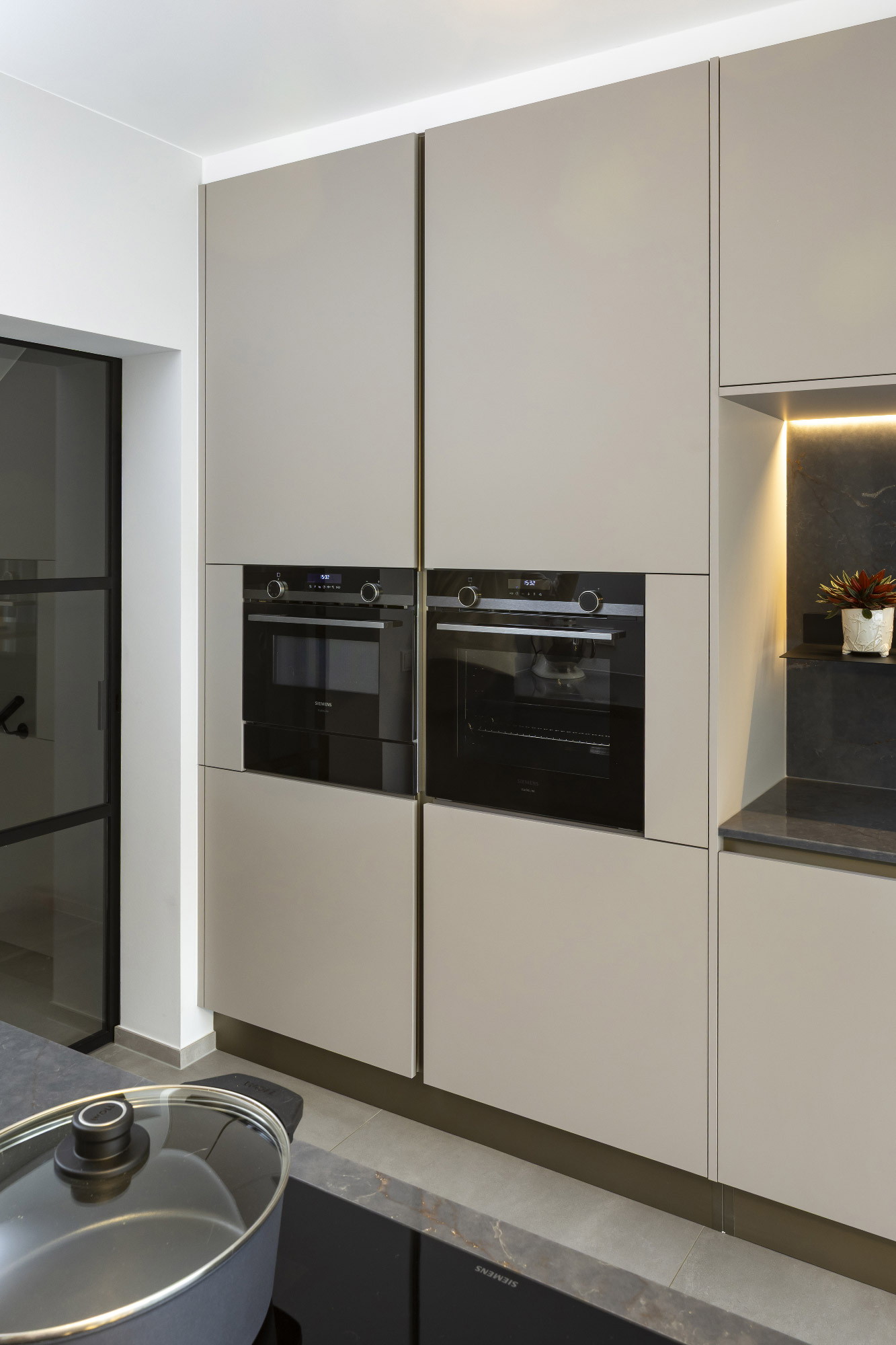 Colonne cucina moderne con forni Siemens a incasso e ante senza maniglie in finitura opaca Sandalo